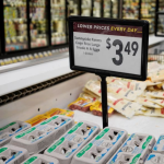 A sign showing the prices of eggs as $3.49.